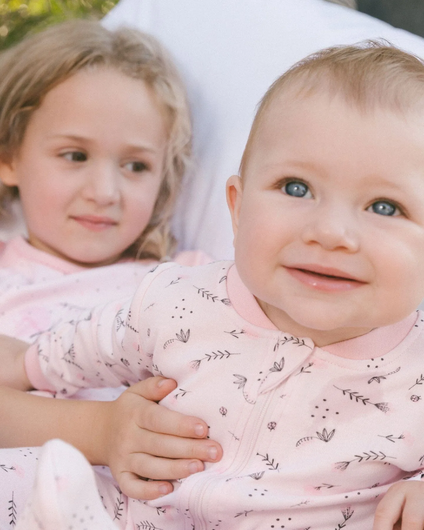 Printed Organic Cotton One-Piece Pajama Small Pink Flowers On Pale Pink Background