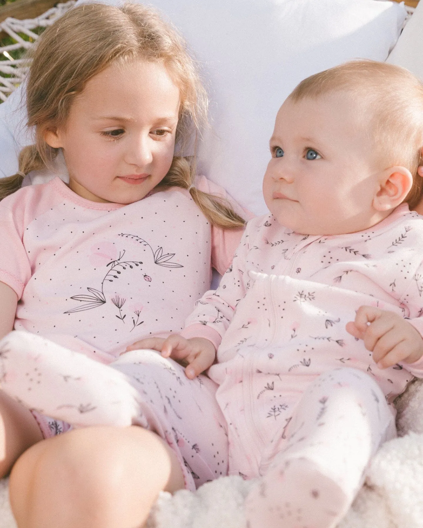 Printed Organic Cotton One-Piece Pajama Small Pink Flowers On Pale Pink Background